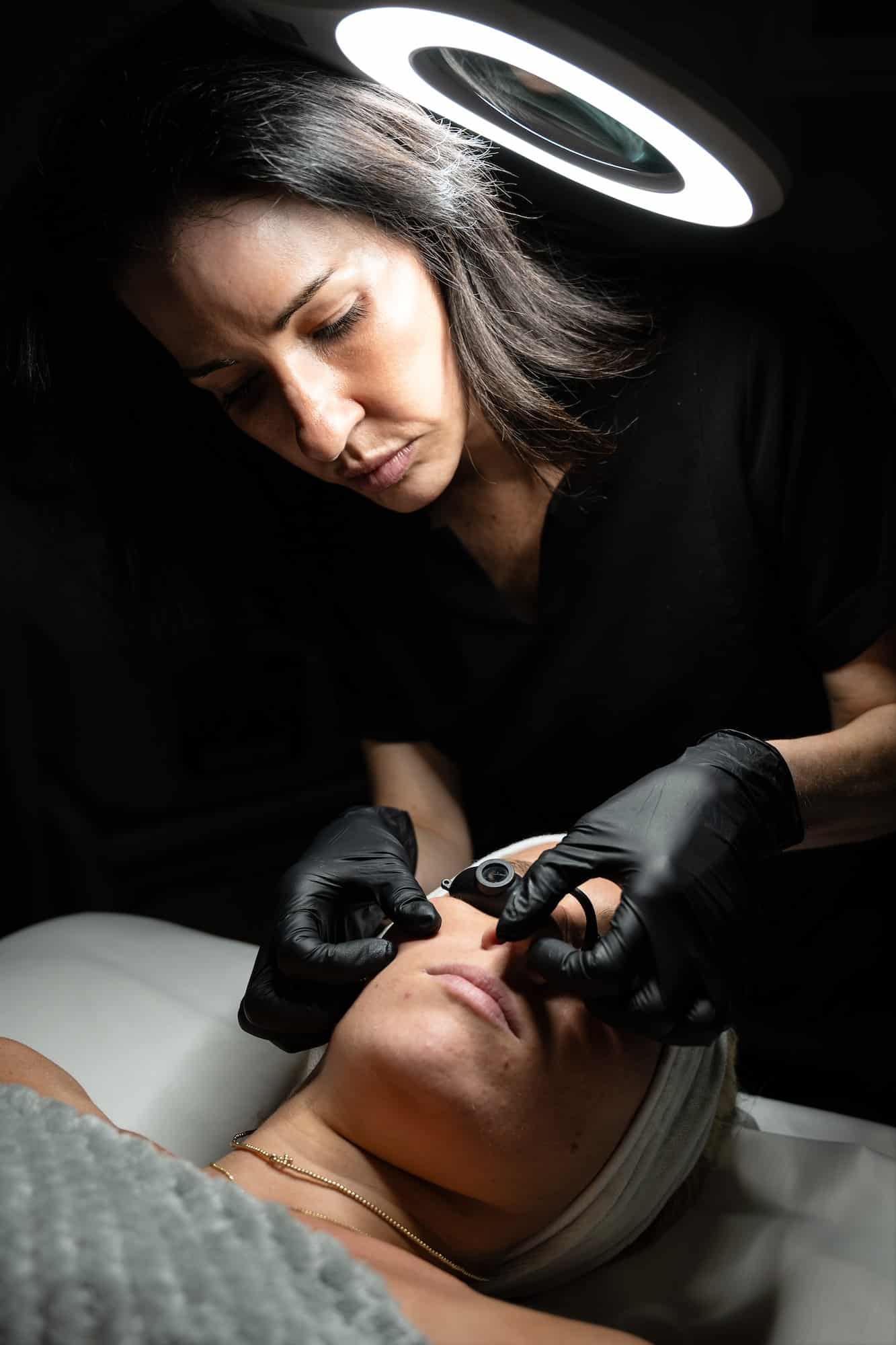 Provider performing a targeted facial treatment to improve skin clarity and reduce visible discoloration