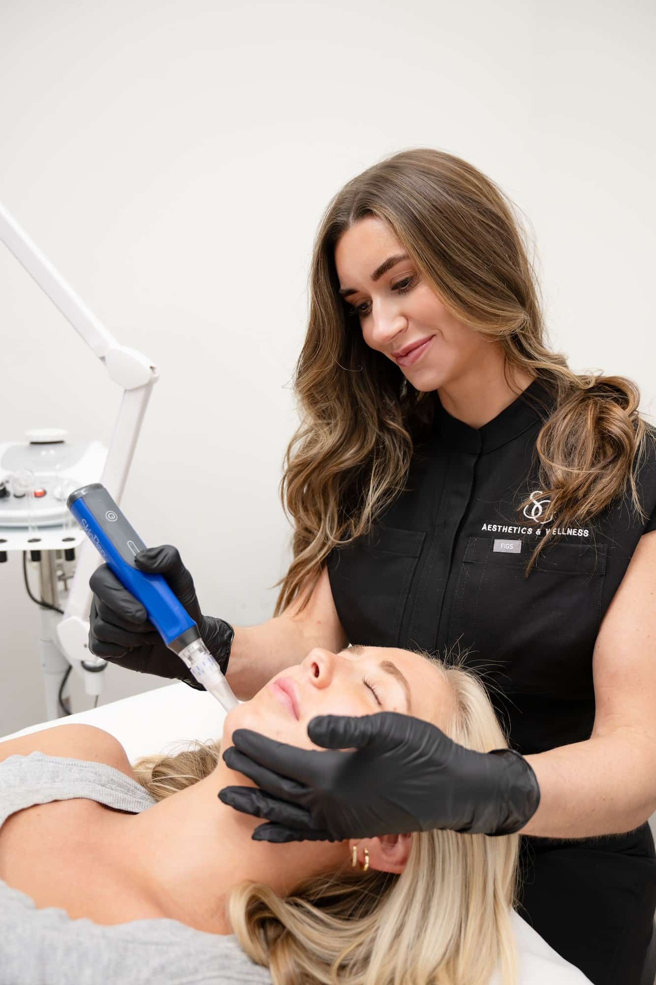 Provider performing a facial treatment to improve skin texture and reduce signs of aging - SG Aesthetics & Wellness Provider performing a facial treatment to improve skin texture and reduce signs of aging